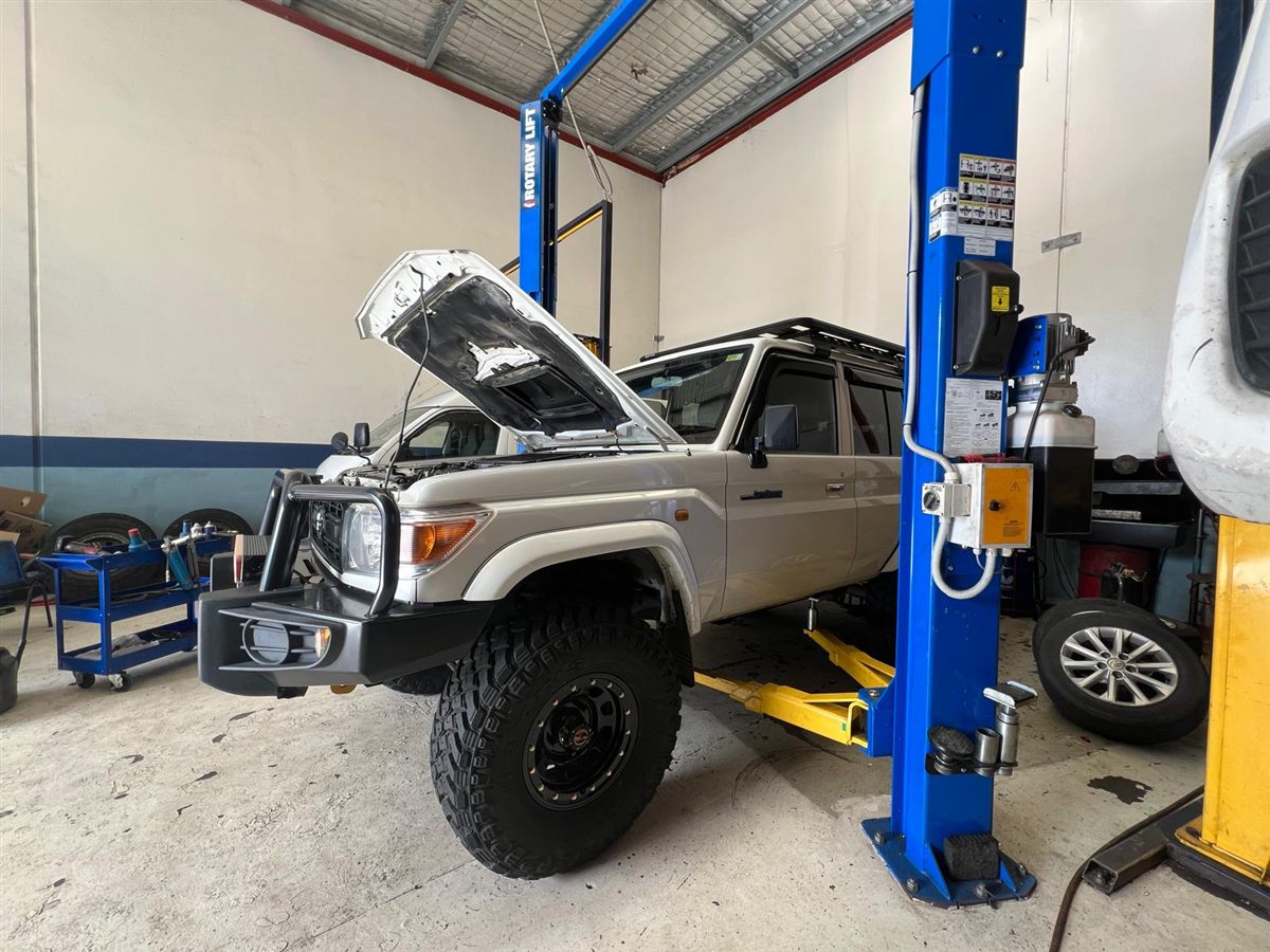 An Action Installation and Services truck being worked on in the bay
