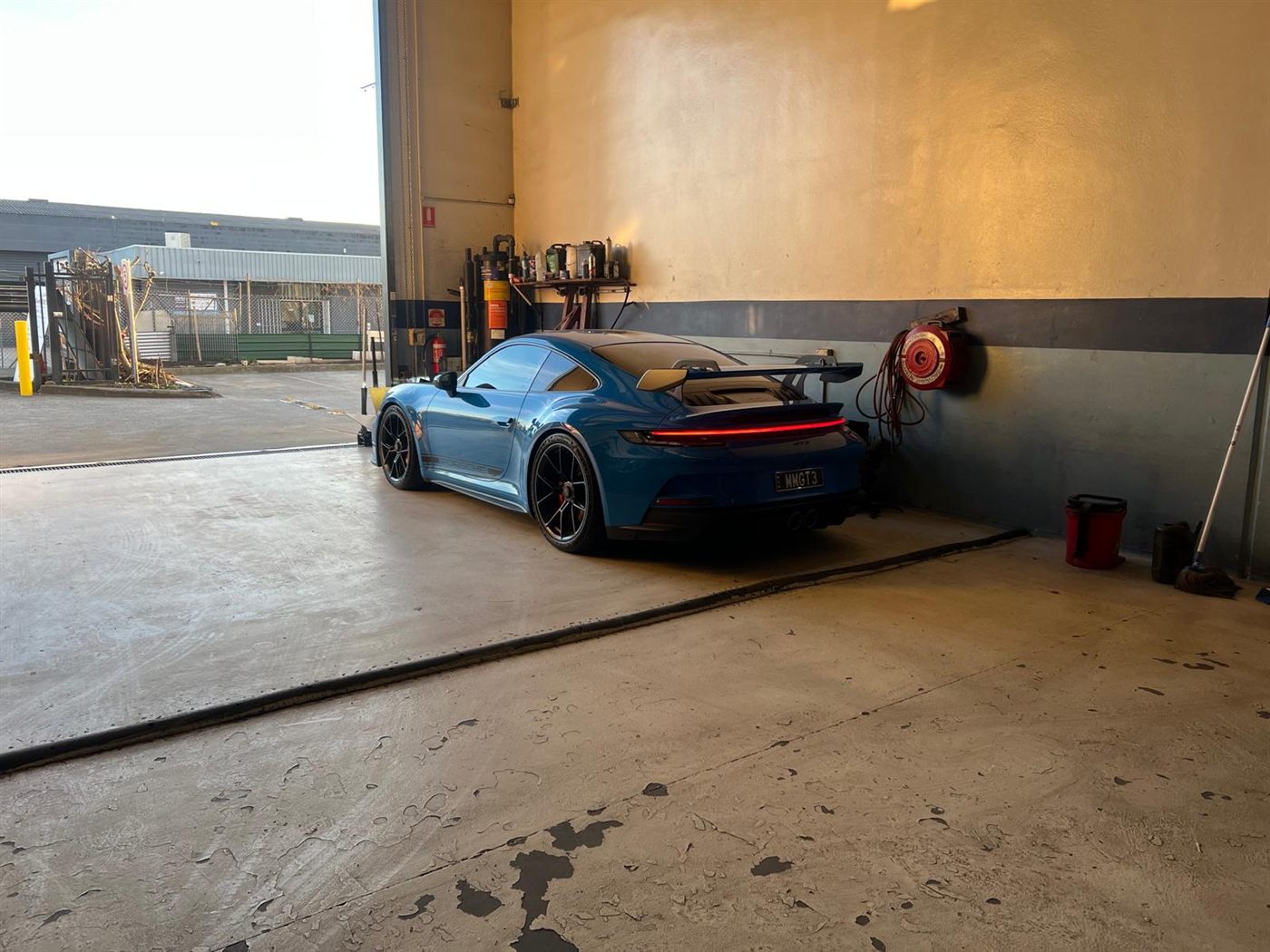 A Porsche 911 GT3 parked in the workshop bay
