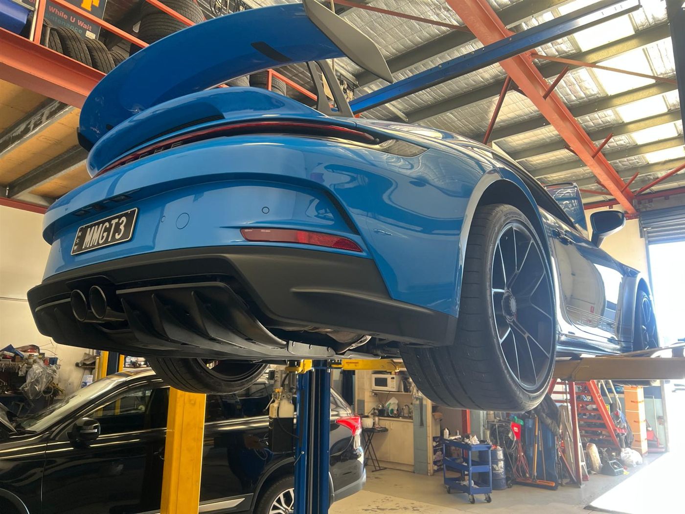 Close-up of a Porsche 911 GT3 on a hoist